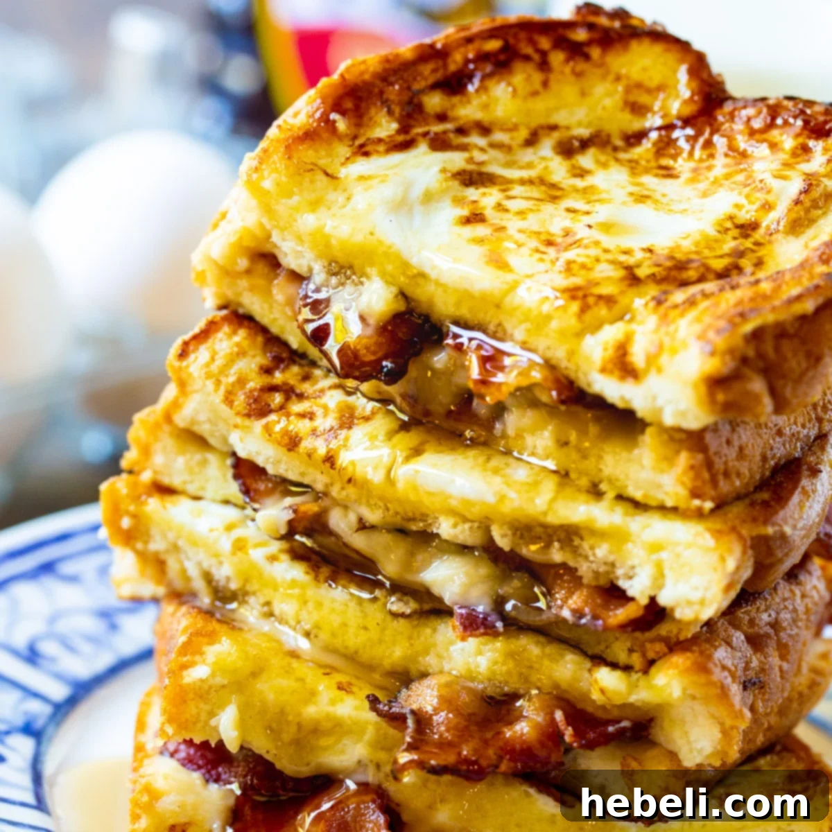 Stacked Bacon Stuffed French Toast with a generous drizzle of golden maple syrup
