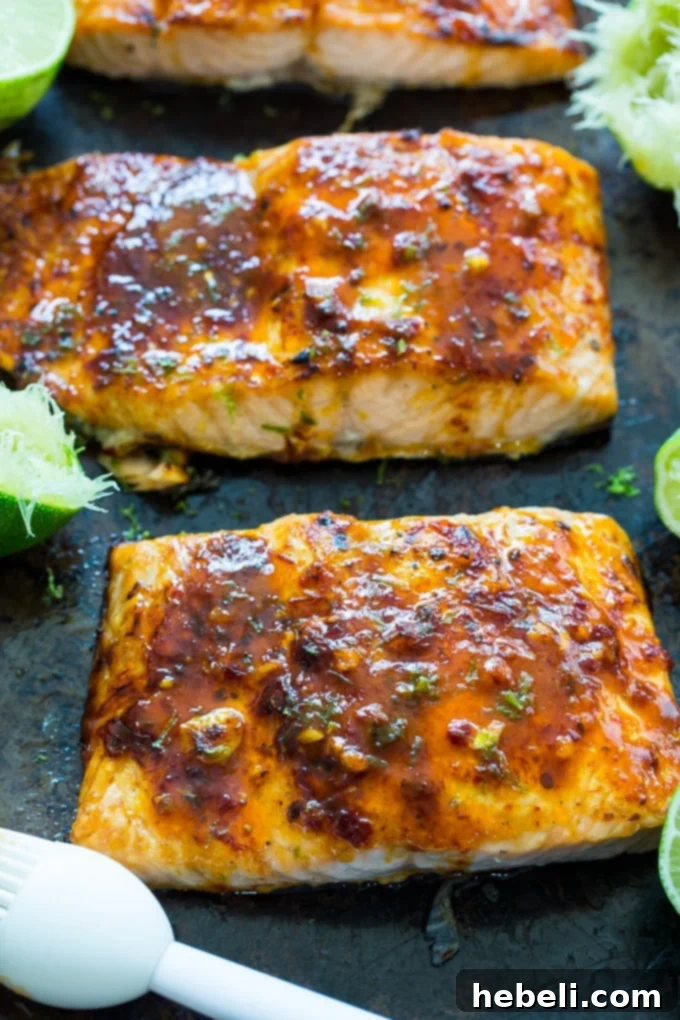 Close-up of broiled Chipotle Lime Salmon with lime wedges