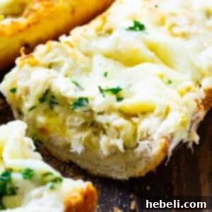 A slice of Artichoke and Crab Dip Bread with a beautiful, golden-brown crust and creamy filling.