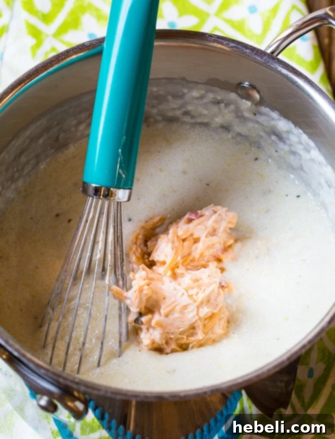 Creamy Pimento Cheese Grits 4 A delectable bowl of Pimento Cheese Grits, showcasing its rich, golden color and inviting texture.