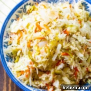 Sweet Vinegar Coleslaw in blue and white bowl, recipe card image.