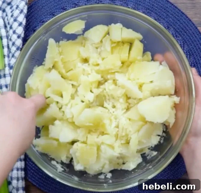 Classic Southern Potato Salad 7 Cutting up cooked potatoes.