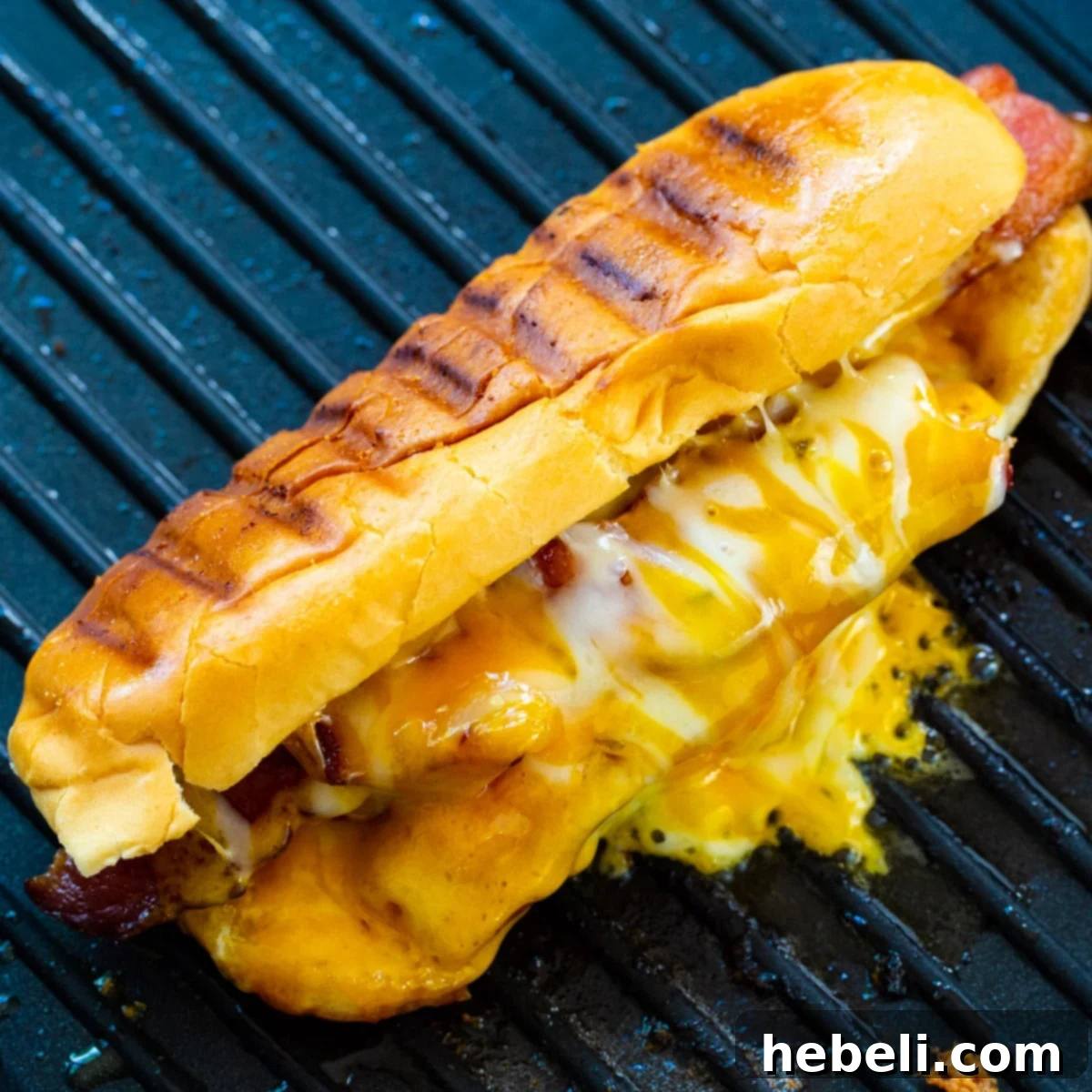 Cheesy Frank Melt 2 Grilled Cheese Hot Dogs on a grill pan, golden brown and cheesy.