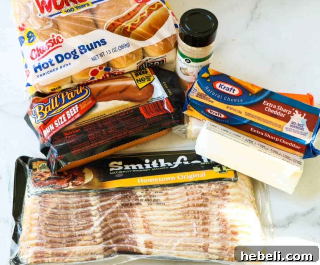 Cheesy Frank Melt 3 A collection of ingredients laid out for making grilled cheese hot dogs, including hot dogs, buns, cheeses, bacon, butter, and garlic powder.