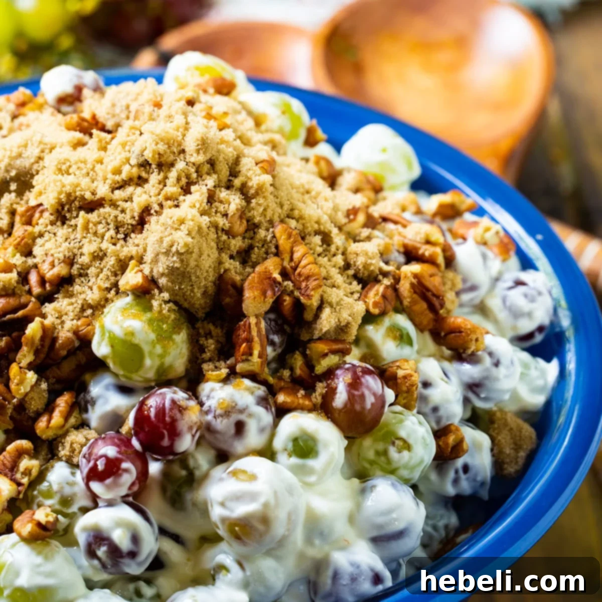 Easy Grape Salad in a vibrant blue serving bowl, garnished with pecans.