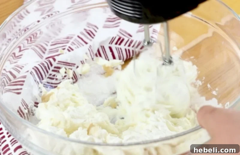 Cream cheese mixture being mixed to a smooth consistency.