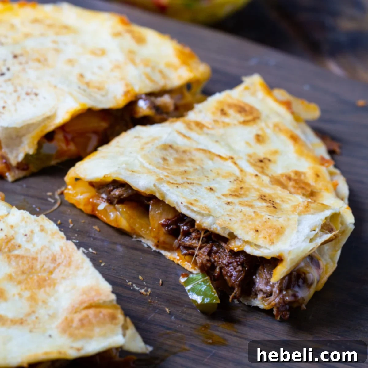 Zesty Beef Quesadillas 2 Crispy Spicy Beef Quesadilla cut into perfect triangles, revealing a rich, cheesy, and spicy beef filling.