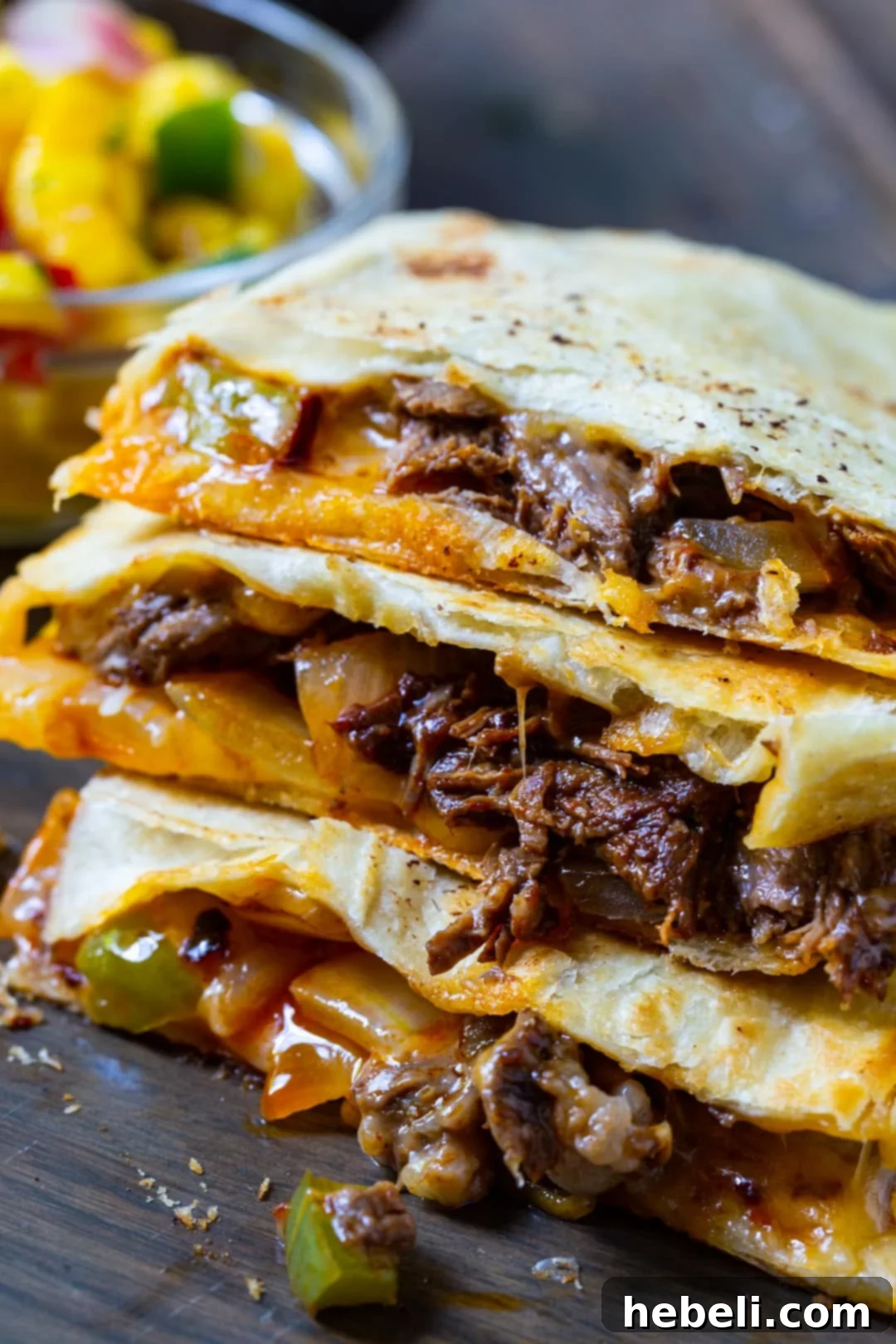 Zesty Beef Quesadillas 3 A stack of golden-brown Spicy Beef Quesadillas, neatly piled and ready to be enjoyed as a meal or appetizer.