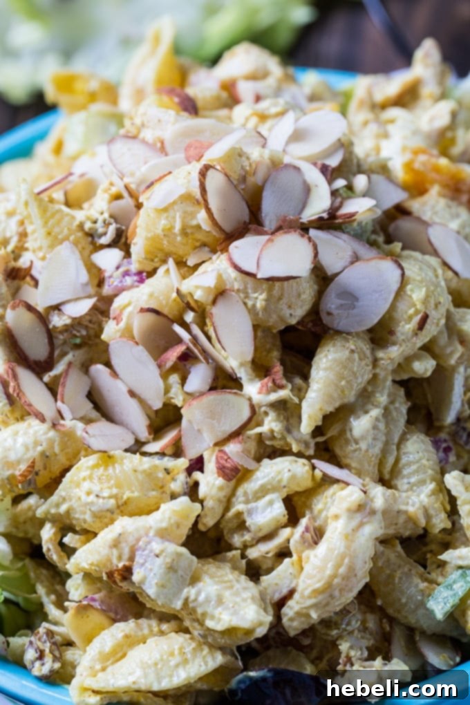 Serving Curry Chicken Pasta Salad on a bed of lettuce