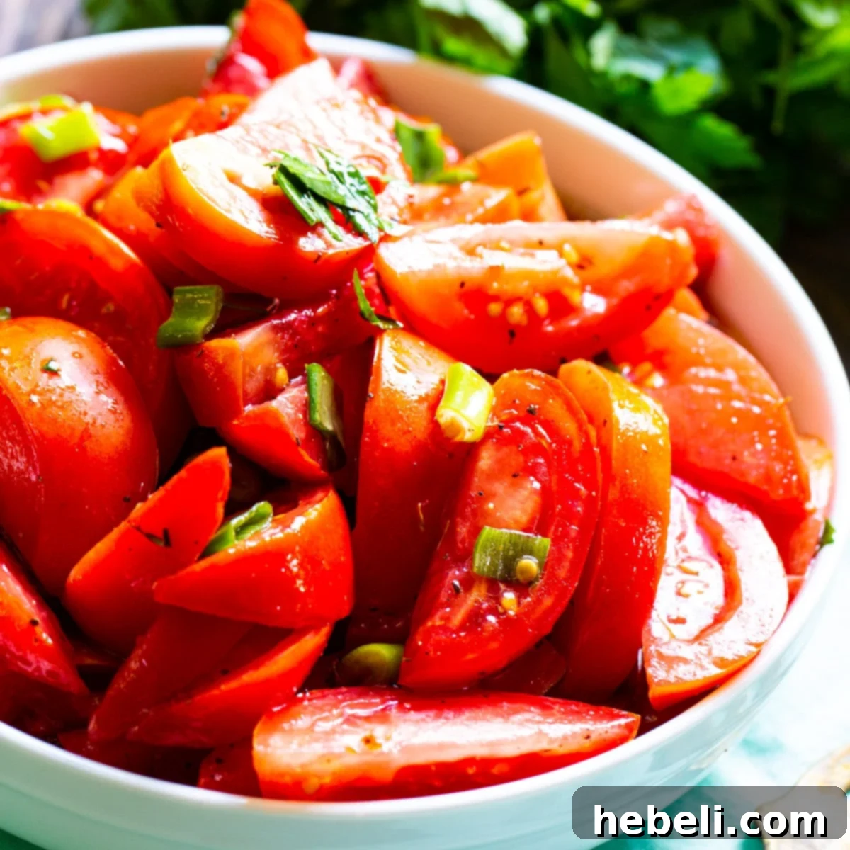 Zesty Marinated Tomatoes 2 Freshly Marinated Tomatoes served in a white bowl, ready to eat.
