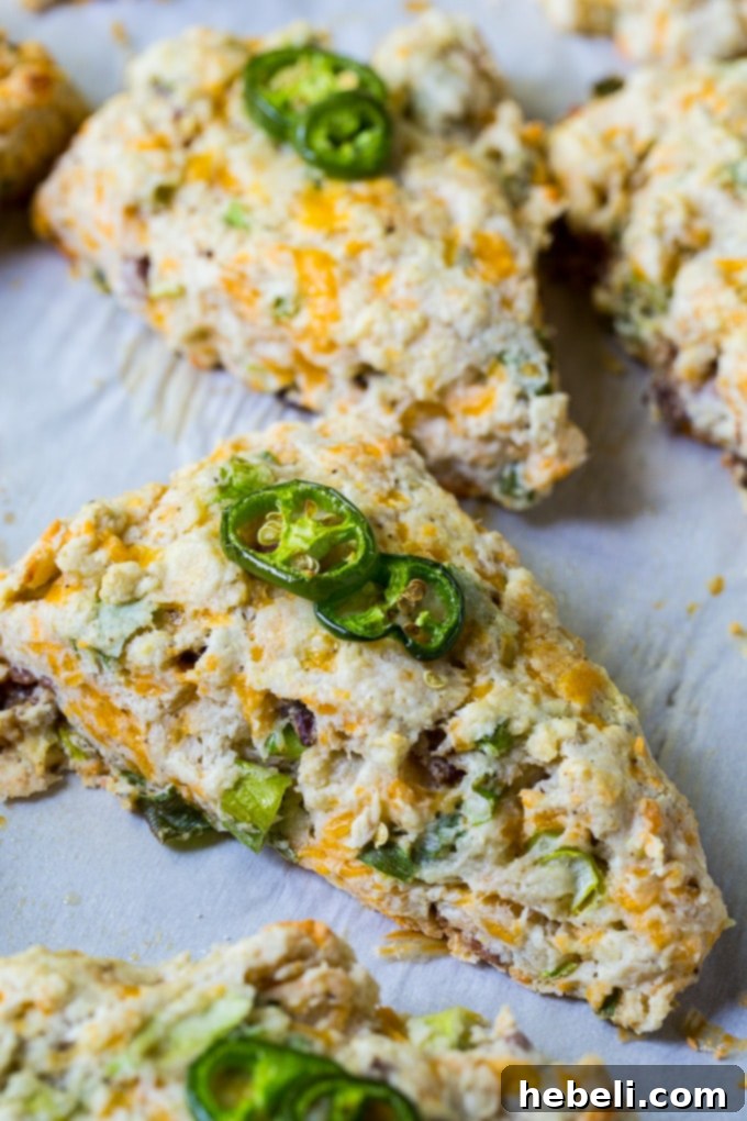 Savory Jalapeno Bacon Scones 3 Close-up of a stack of golden brown Jalapeno Bacon Scones, revealing crispy bacon and cheese pockets.