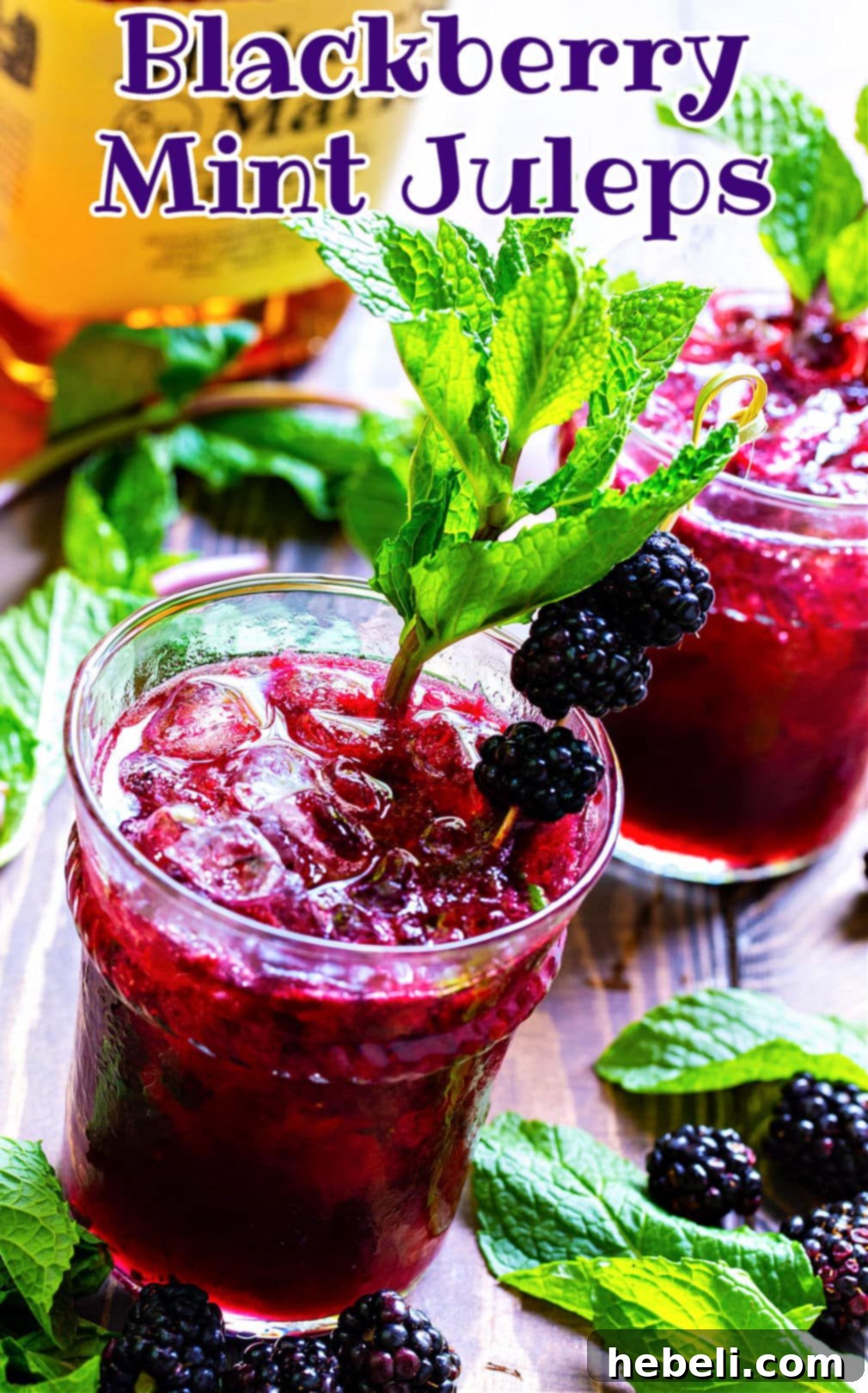Blackberry Mint Julep Delights 4 Two perfectly prepared Blackberry Mint Juleps in julep glasses, garnished with mint and blackberries, ready to be enjoyed.