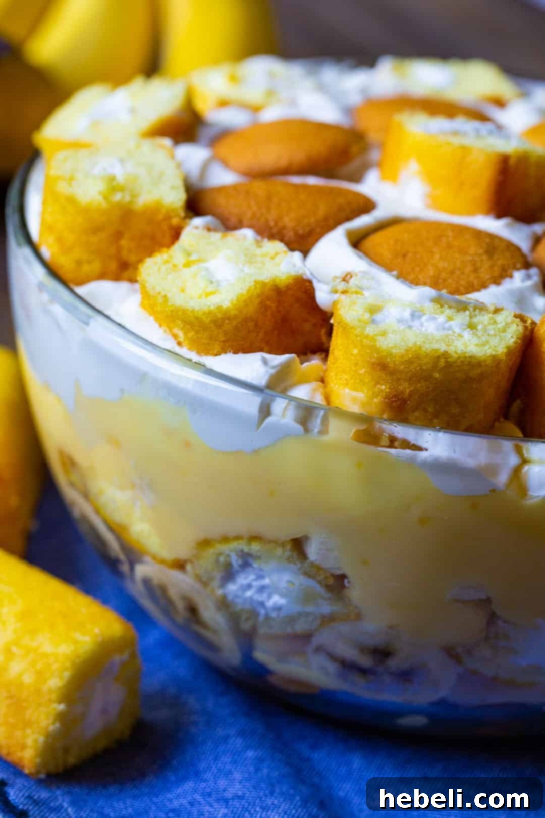 A side view of the delicious Twinkie Banana Pudding presented in a clear glass bowl, showing off its distinct layers.