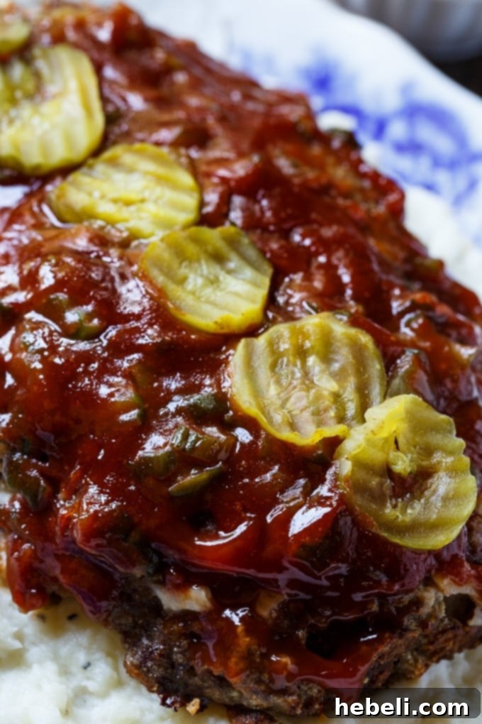 Flavorful Dill Pickle Meatloaf, infused with pickle juice and topped with chopped pickles