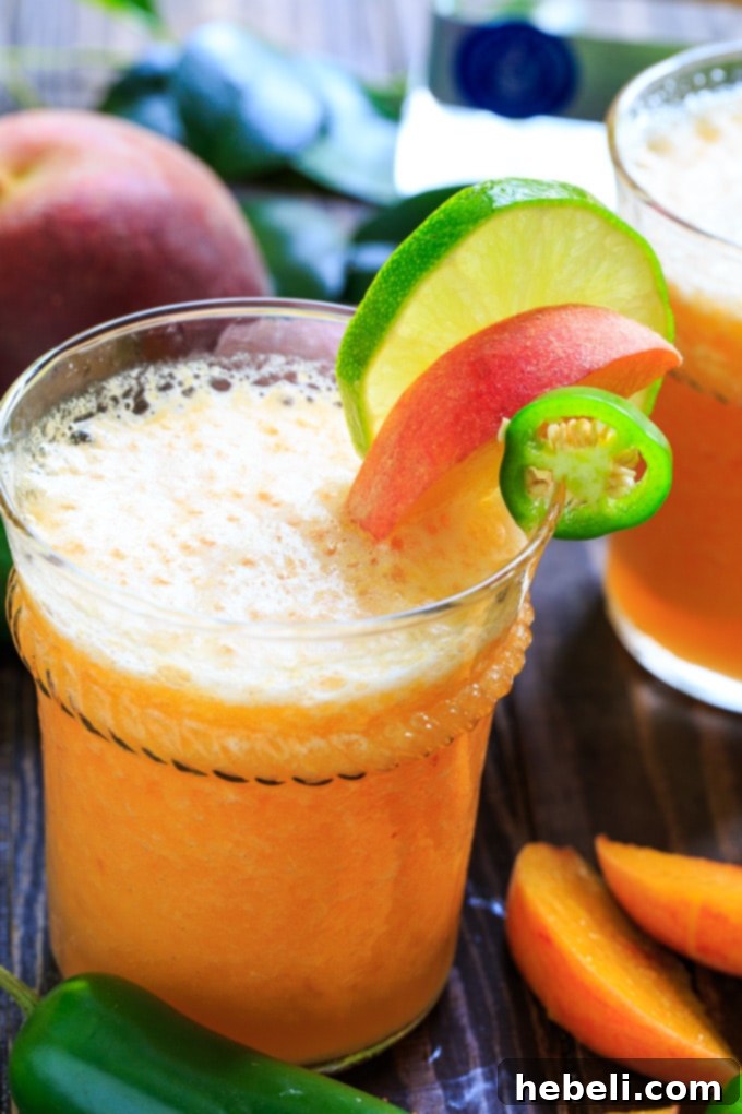Sweet Heat Peach Margarita 5 Several glasses of Peach Jalapeno Margaritas ready to be served on a tray, with fresh peach slices.
