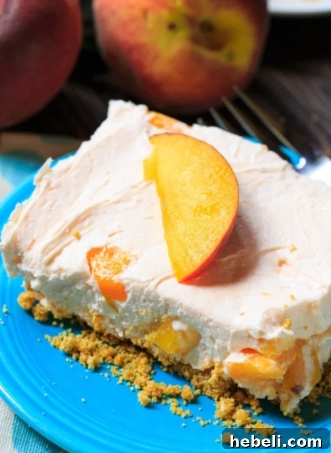 Close-up of ingredients for No-Bake Peach Cheesecake Bars including fresh peaches, cream cheese, and Cool Whip on a counter