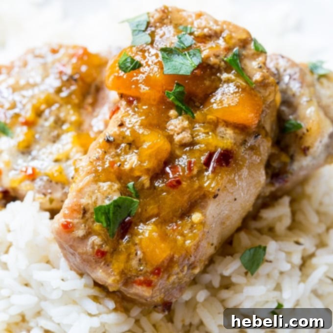 Slow Cooker Spicy Peach Glazed Pork Chops, showcasing the delicious glaze and tender pork.