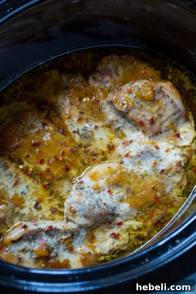 Pork chops cooked in the crockpot with spicy peach glaze, ready to be served.