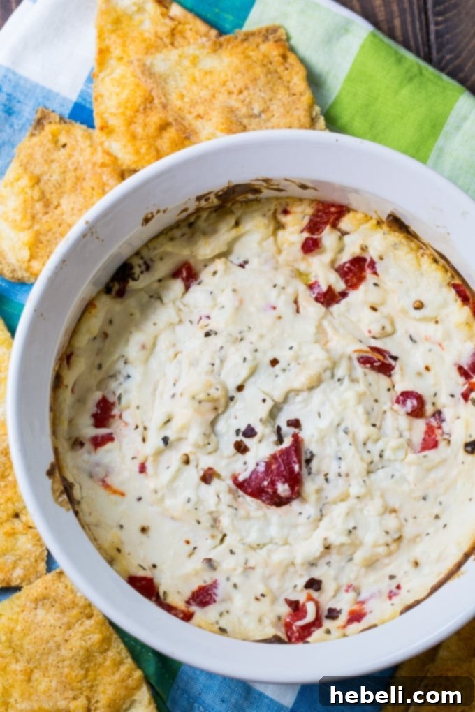 Baked Feta Cheese Dip in a white baking dish, fresh out of the oven, ready to be served with crusty bread.