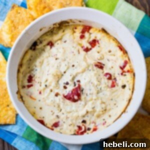 Spicy Warm Feta Cheese Dip in a bowl with herbs.
