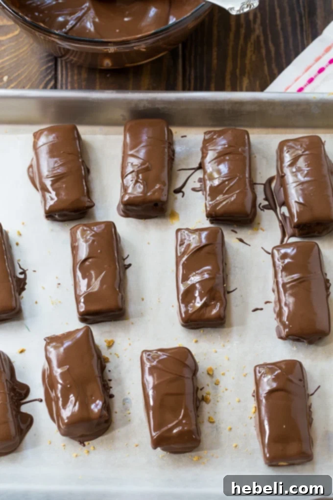 Decadent Chocolate Peanut Butter Graham Bites 3 Close-up of graham crackers stuffed with peanut butter, waiting to be coated in chocolate.