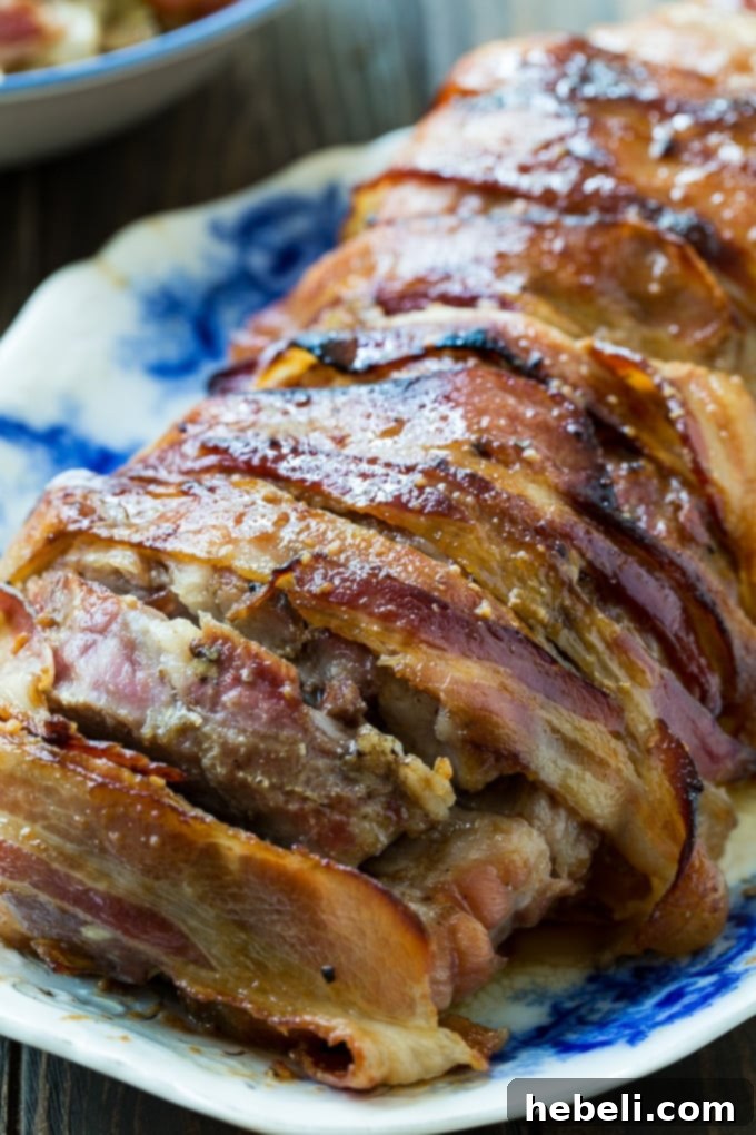 Cooked Bacon Wrapped Maple Glazed Pork Loin, ready to be carved.