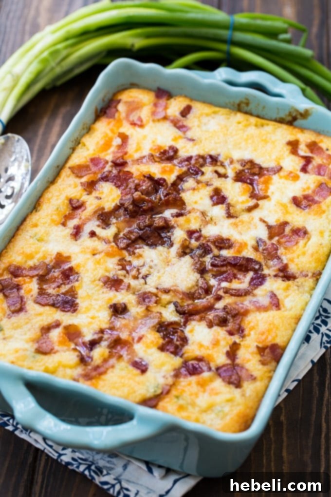 Savory Cheesy Bacon Grits Bake 3 Close-up shot of a serving of Cheese and Bacon Grits Casserole, highlighting its creamy texture and bacon topping.