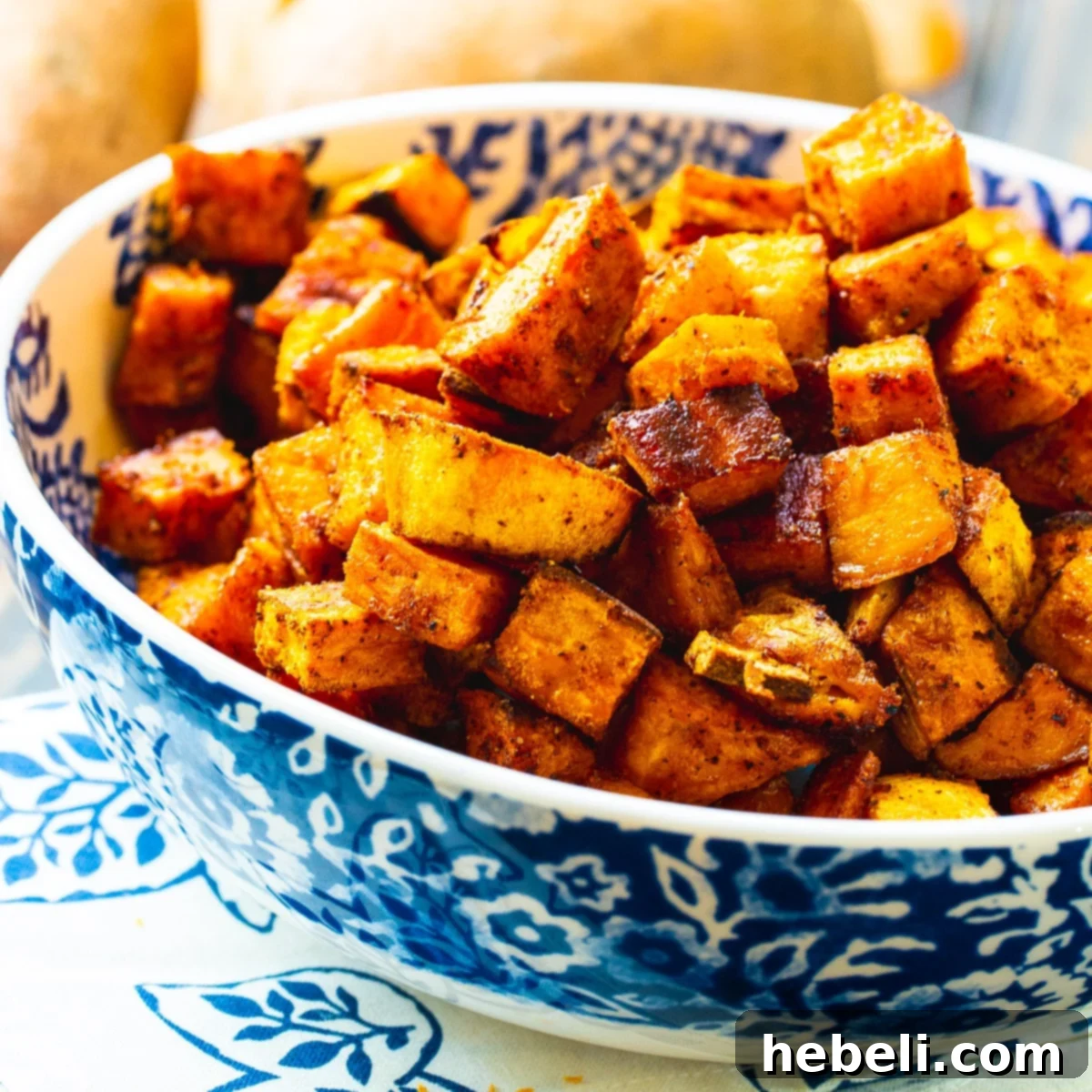 Sweet Heat Roasted Sweet Potatoes 2 Bowl full of Spicy-Sweet Roasted Sweet Potatoes, garnished and ready to serve