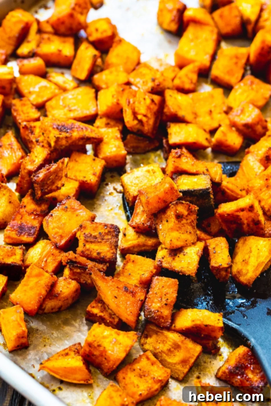 Sweet Heat Roasted Sweet Potatoes 5 Crispy Spicy-Sweet Roasted Sweet Potatoes cooling on a baking sheet after being removed from the oven