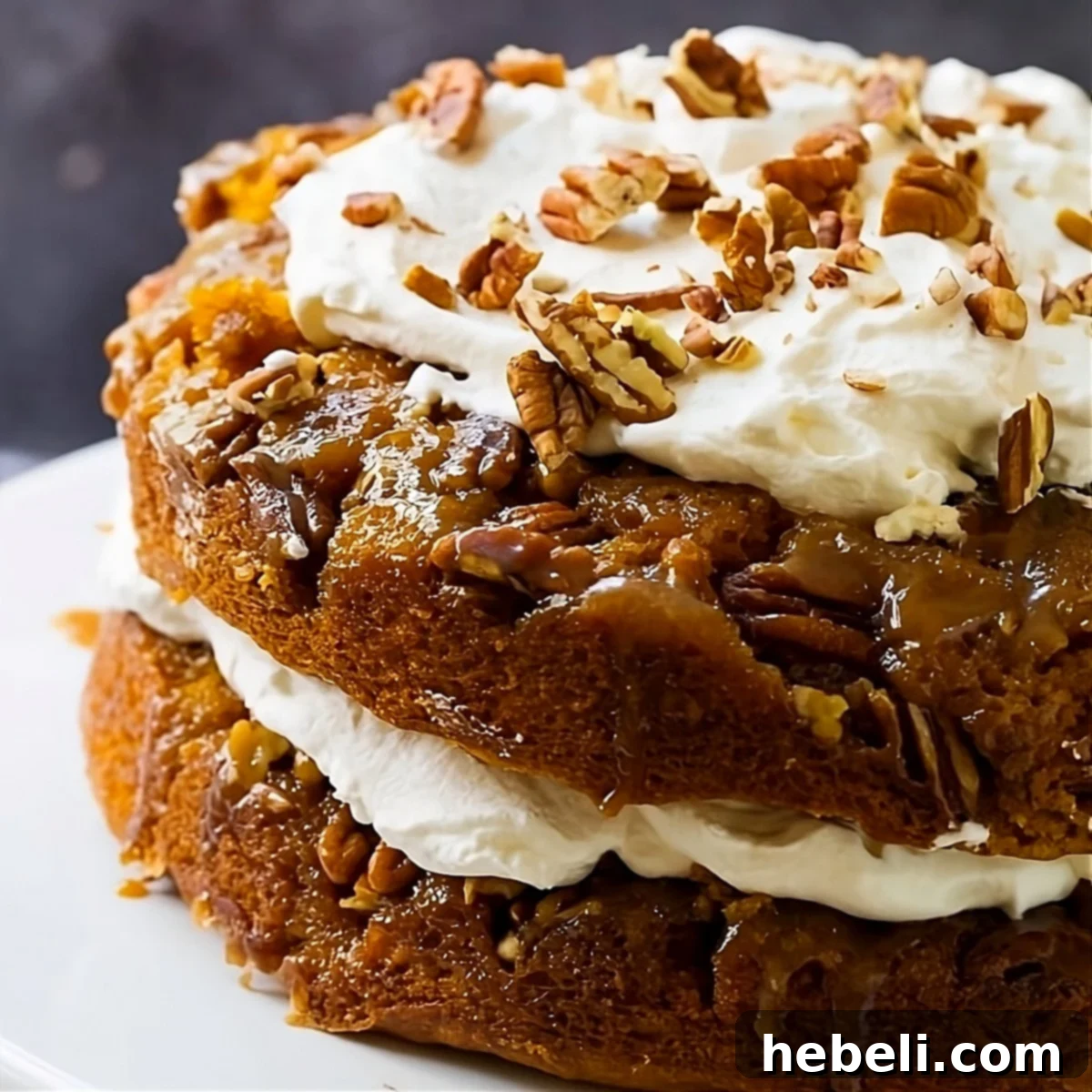 Decadent Pumpkin Praline Torte 2 Pumpkin Praline Cake on a cake stand, showcasing its layers and topping.
