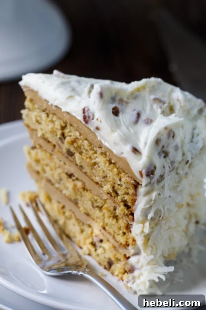 Close-up of a slice of Caramel Italian Cream Cake with layered frostings