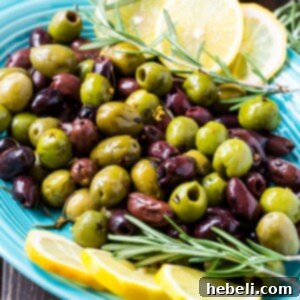 Warm Rosemary Olives served in a rustic bowl.