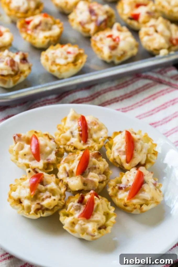 An appetizing close-up of Mini Hot Brown Tarts, showing their golden crust and rich filling.