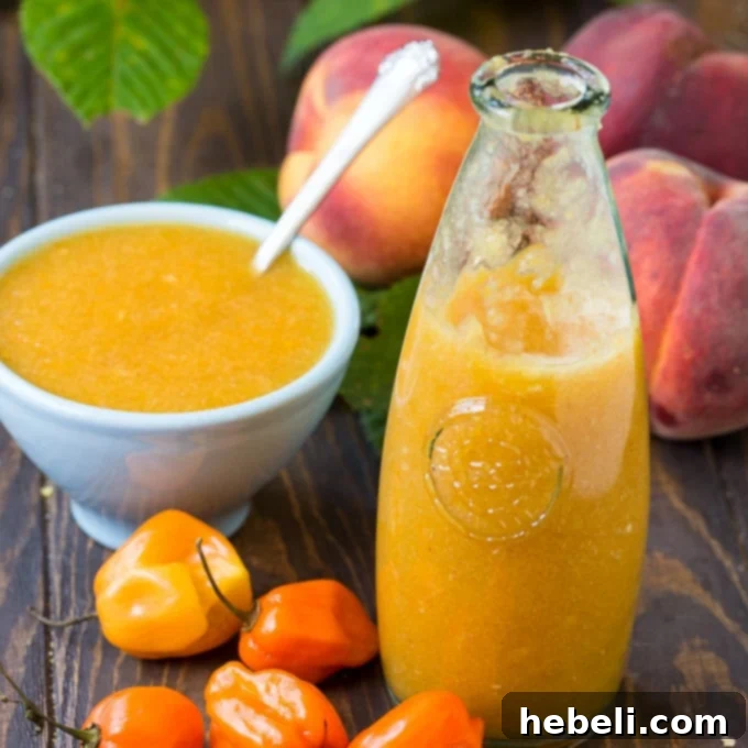 Homemade Peach Habanero Hot Sauce in a jar, showcasing its vibrant color and smooth texture.