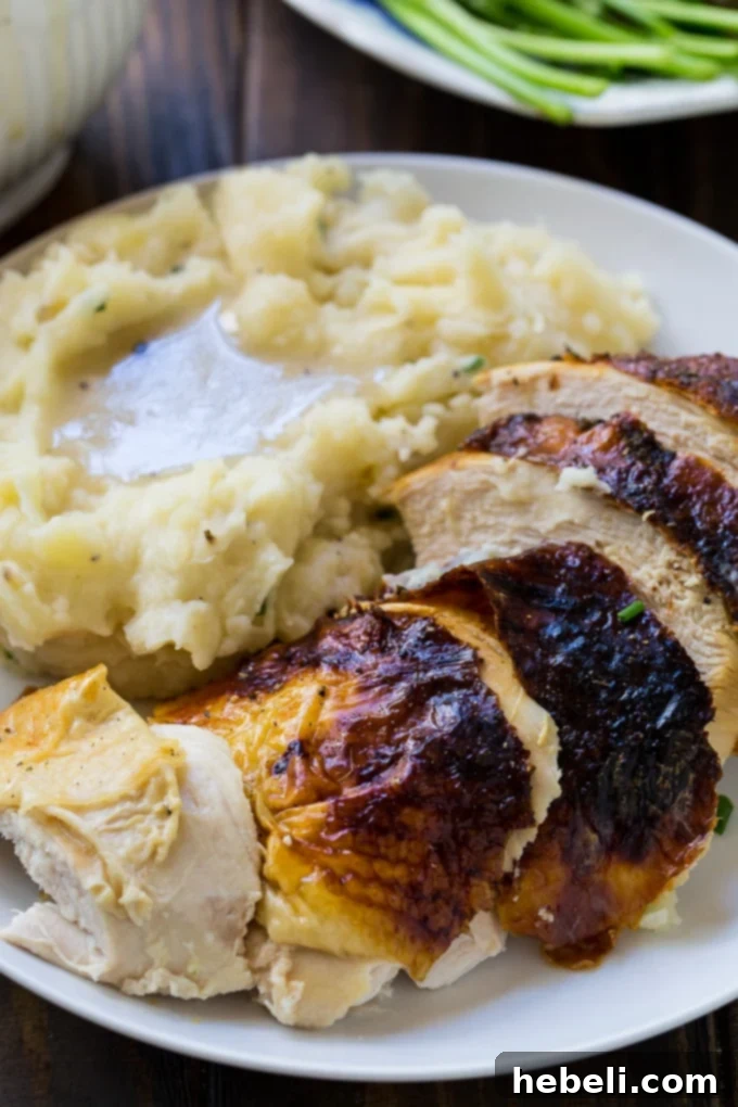 Perfectly sliced Buttermilk Marinated Turkey Breast with gravy, ready to be served on a platter.