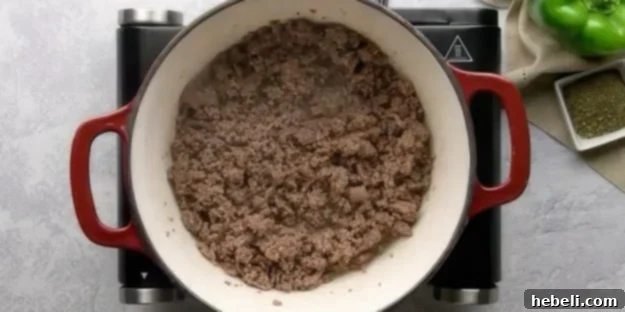 Browned ground beef in a Dutch oven, ready for the next ingredients.
