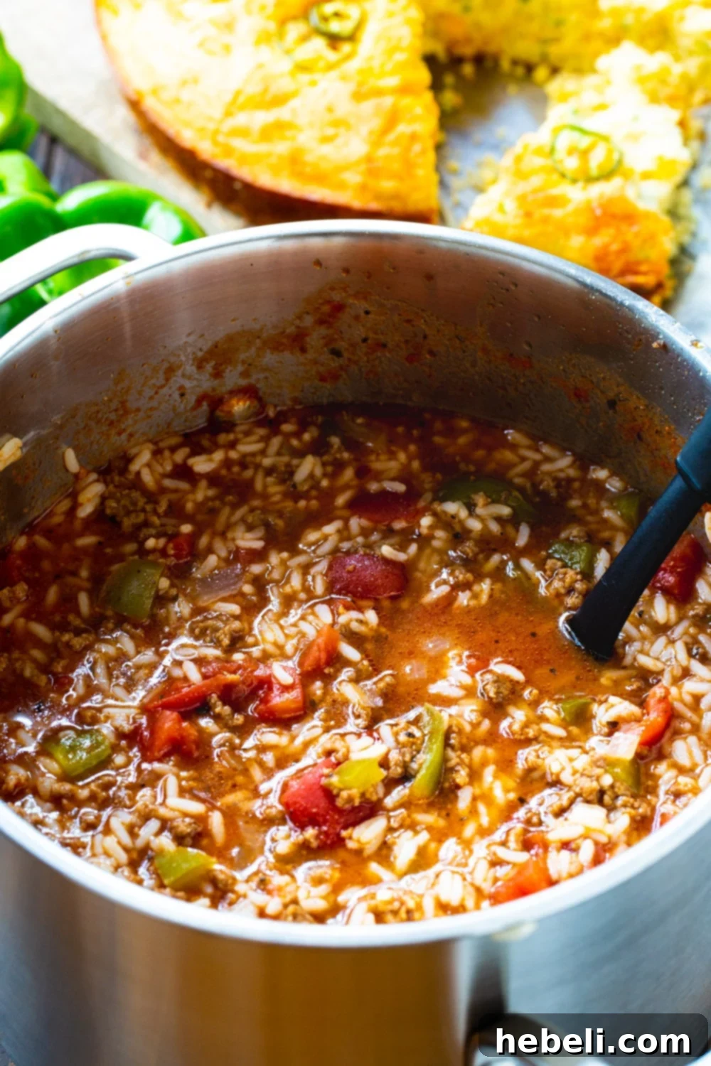 A large pot of Stuffed Pepper Soup served with a side of cornbread.