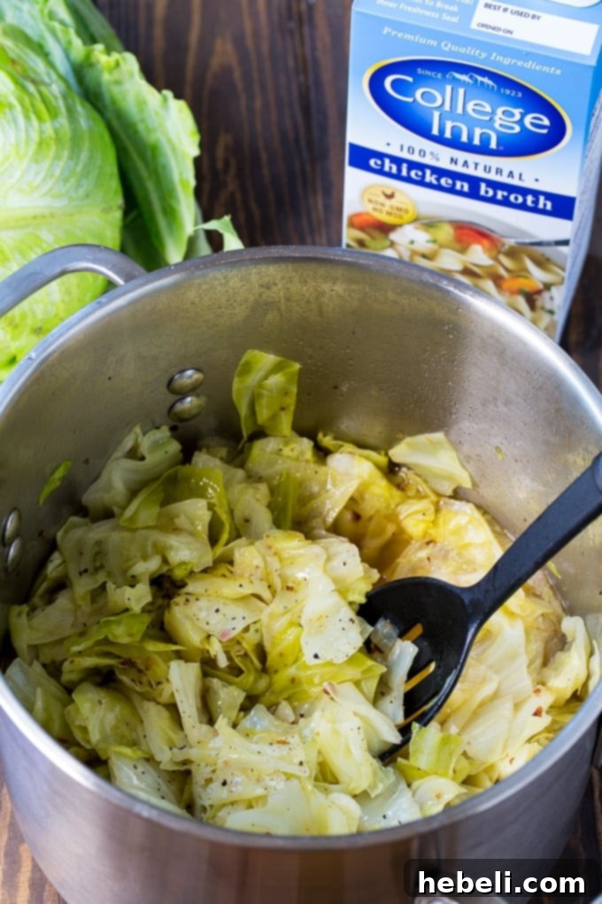 A serving of Southern Cabbage in a small bowl with visible broth and bacon bits