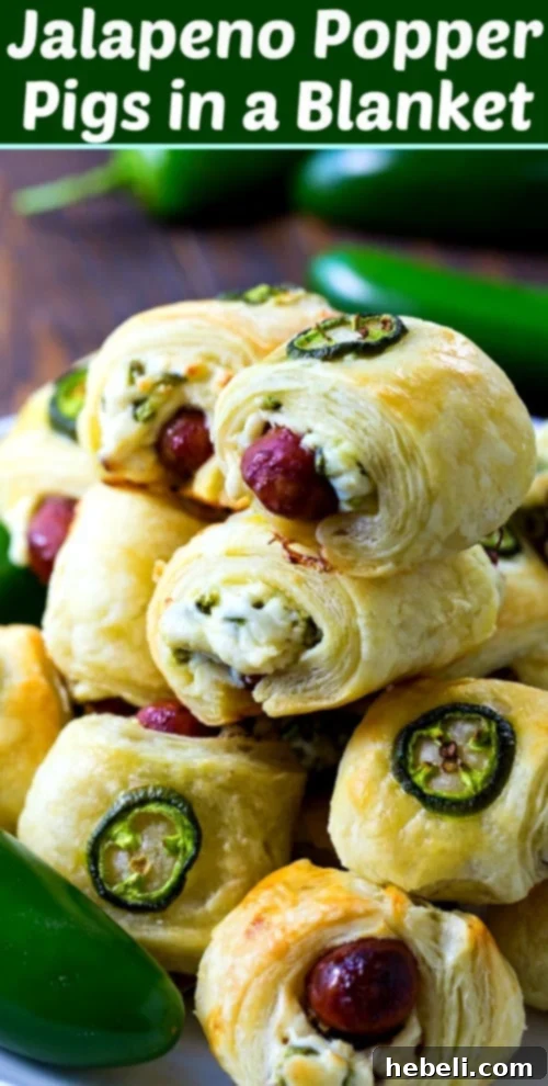 Spicy Piggy Poppers 8 Stacked Jalapeno Popper Pigs in a Blanket on a board, with the hashtag #appetizer #spicy #gameday, highlighting its popularity for various occasions.