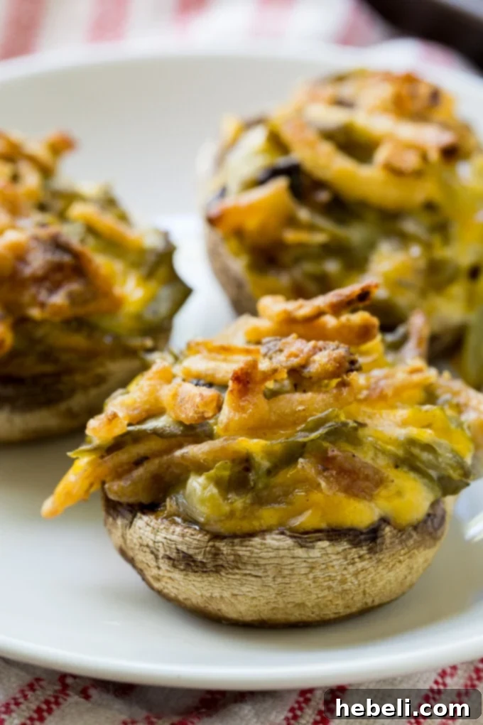 Green Bean Casserole Mushroom Bites 4 A baking sheet filled with raw Green Bean Casserole Stuffed Mushrooms, showcasing the prepared filling in mushroom caps, ready for the oven
