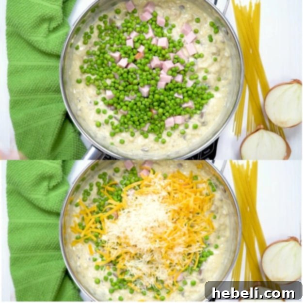 Cubed ham, green peas, and shredded cheddar and Parmesan cheeses being added to the creamy sauce in the skillet.