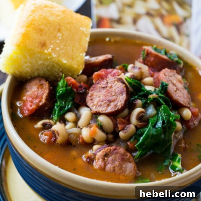 Hearty Black-Eyed Pea Stew with Smoked Sausage and Kale, served with cornbread