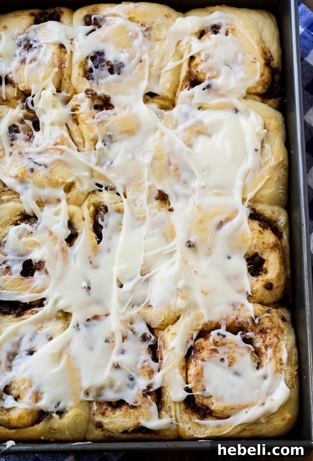 Sweet & Savory Sausage Cinnamon Rolls 3 Freshly baked Sausage Cinnamon Rolls nestled in a baking dish, warm and ready for frosting.