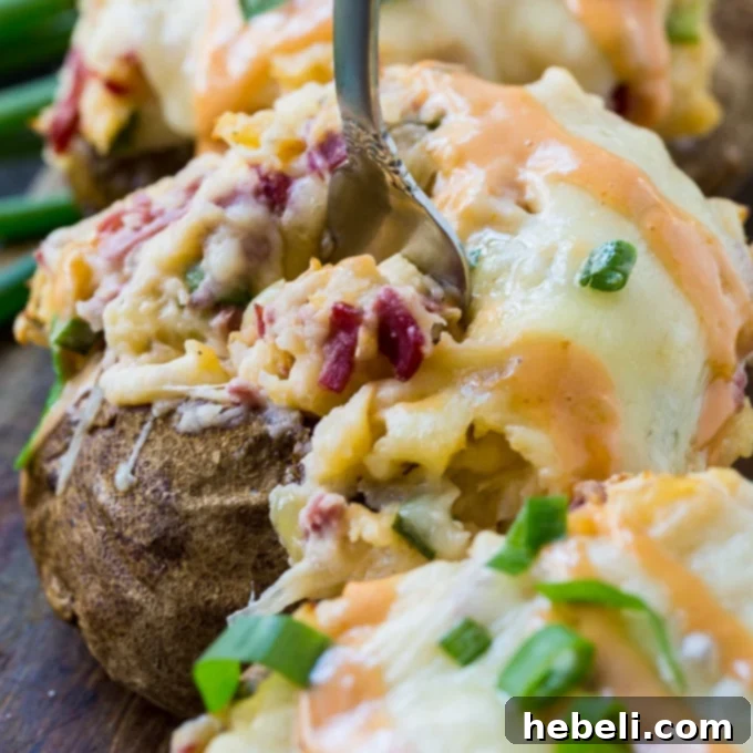 Reuben Stuffed Potatoes, golden brown with melted cheese and fresh green onions