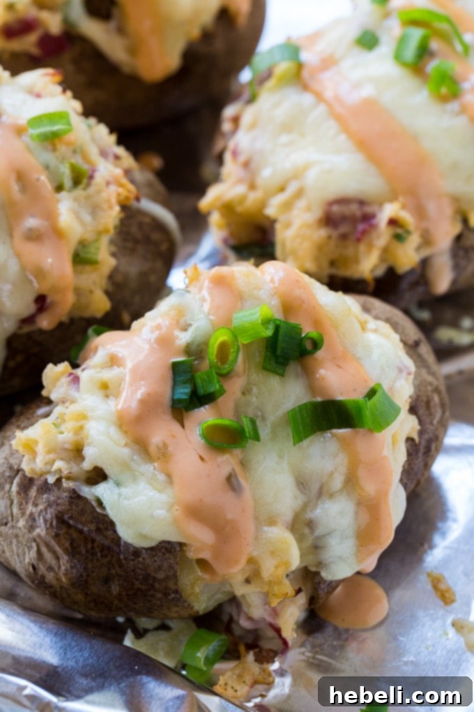 Close-up of a golden-brown Reuben Baked Potato with melted cheese on top