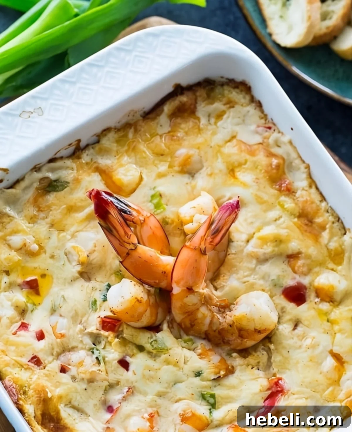 Spicy Shrimp Dip in a baking dish, golden brown and bubbling.