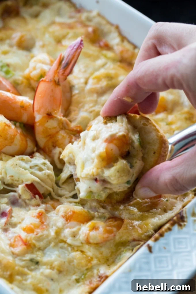 Close-up of creamy and cheesy Spicy Shrimp Dip baking in the oven.