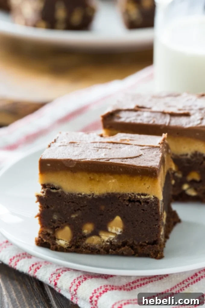 Individual square of Double Frosted Peanut Butter Brownies on a serving plate, showing the distinct frosting layers.