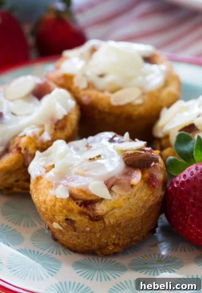 Unrolled crescent roll dough being prepared for strawberry danishes