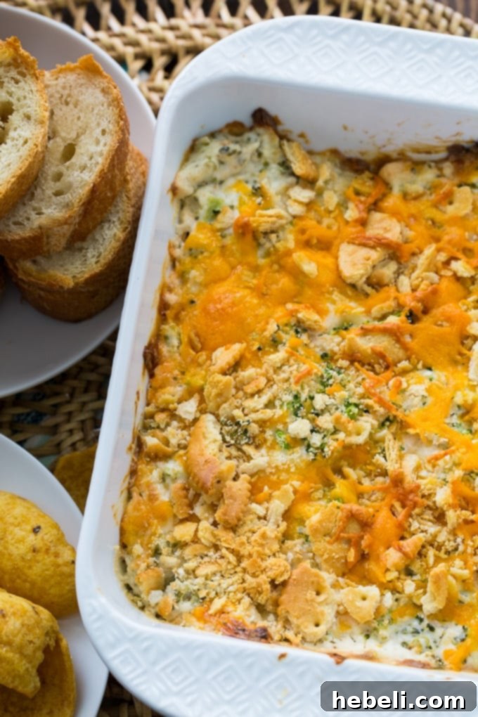 Close-up view of creamy broccoli cheese dip, showcasing its rich, molten texture and perfectly integrated ingredients.